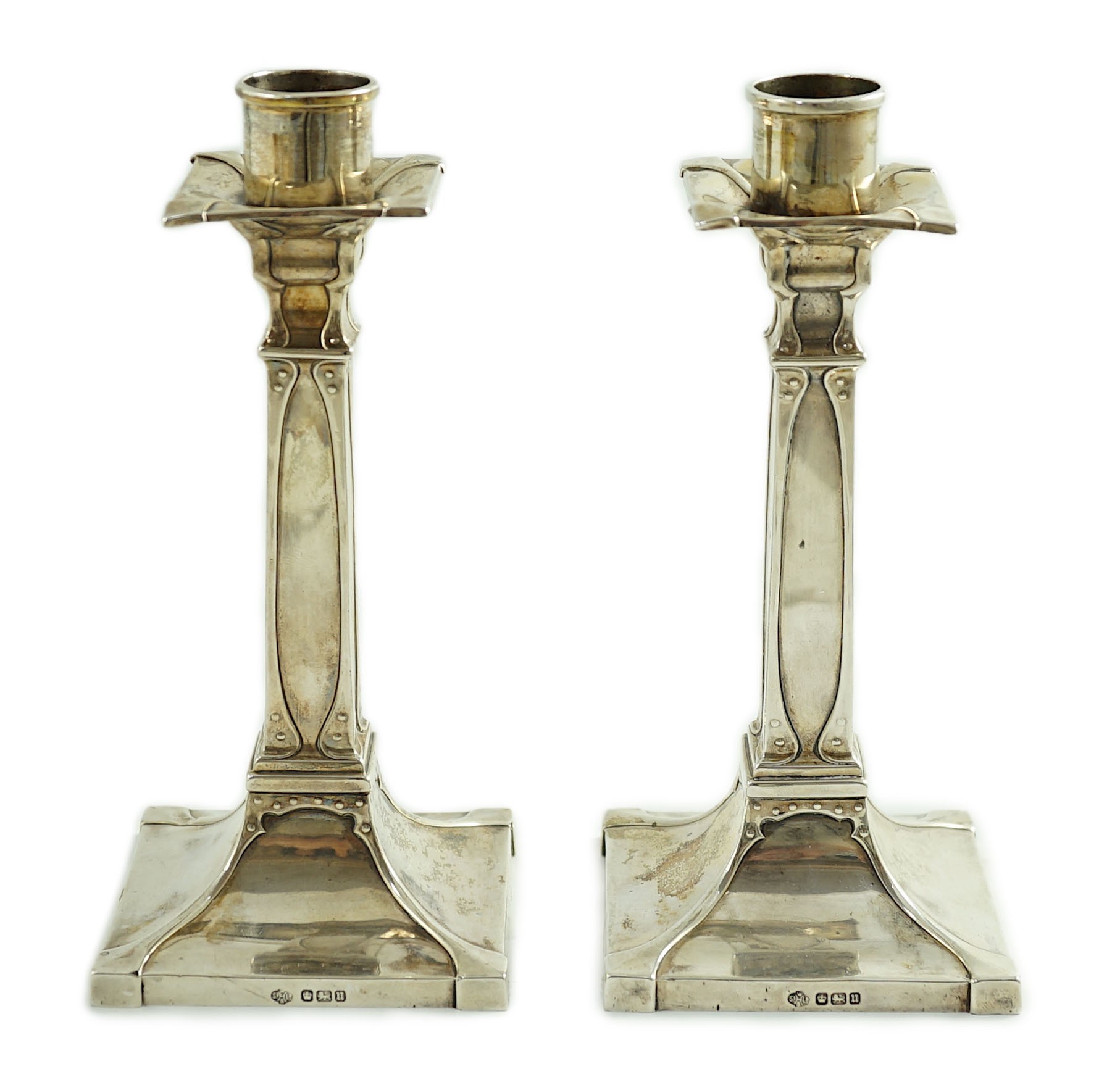 A pair of George V Arts & Crafts silver candlesticks, by William Hutton & Sons
